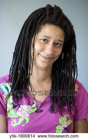Tilburg, Netherlands, Studio Tuinstraat. Portrait of an African-American woman with rasta hair and a smile. View Large Photo Image Picture - Tilburg, Netherlands, Studio Tuinstraat. Portrait of an African-American woman with rasta hair and a smile.. Fotosearch