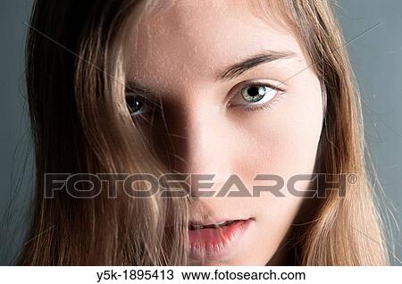 Tilburg, Netherlands. Studio-portrait of a young woman against a grey background. Detailed image, enhanced. View Large Photo Image Stock Image - Tilburg, Netherlands. Studio-portrait of a young woman against a grey background. Detailed image, enhanced.. Fotosearch