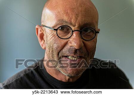 Tilburg, Netherlands. Studio-portrait of a bald, be glassed and middle-aged man, talking, speaking and telling a story. View Large Photo Image Stock Image - Tilburg, Netherlands. Studio-portrait of a bald, be glassed and middle-aged man, talking, speaking and telling a story.. Fotosearch