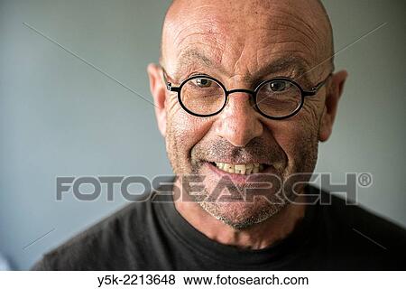 Tilburg, Netherlands. Studio-portrait of a bald, be glassed and middle-aged man, talking, speaking and telling a story. View Large Photo Image Stock Photo - Tilburg, Netherlands. Studio-portrait of a bald, be glassed and middle-aged man, talking, speaking and telling a story.. Fotosearch