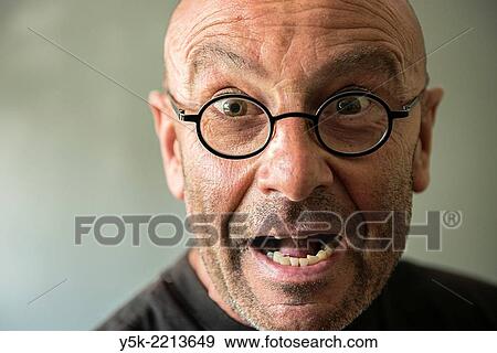 Tilburg, Netherlands. Studio-portrait of a bald, be glassed and middle-aged man, talking, speaking and telling a story. View Large Photo Image Stock Photo - Tilburg, Netherlands. Studio-portrait of a bald, be glassed and middle-aged man, talking, speaking and telling a story.. Fotosearch