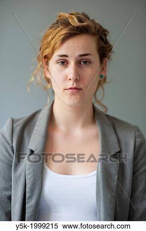 Tilburg, Netherlands. Studio-portrait of a young woman against a grey background, looking into the camera. Front view. View Large Photo Image Stock Photography - Tilburg, Netherlands. Studio-portrait of a young woman against a grey background, looking into the camera. Front view.. Fotosearch
