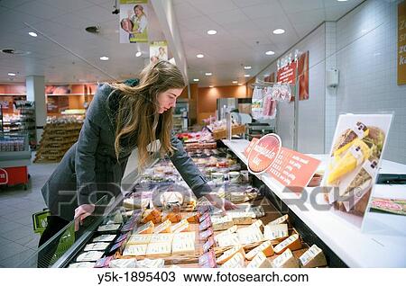 Tilburg, Netherlands. Young woman buying groceries in a supermarket. View Large Photo Image Stock Image - Tilburg, Netherlands. Young woman buying groceries in a supermarket.. Fotosearch