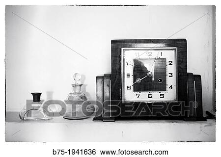 time clock on a shelf with two old perfume bottles View Large Photo Image Stock Photograph - time clock on a shelf with two old perfume bottles. Fotosearch