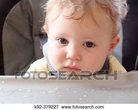 Tired one year old boy after eating View Large Photo Image Stock Photo - Tired one year old boy after eating. Fotosearch
