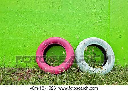 Stock Photograph - Tires leaning against painted wall, Bright Puerto Rican colors, San Juan, Puerto Rico. Fotosearch