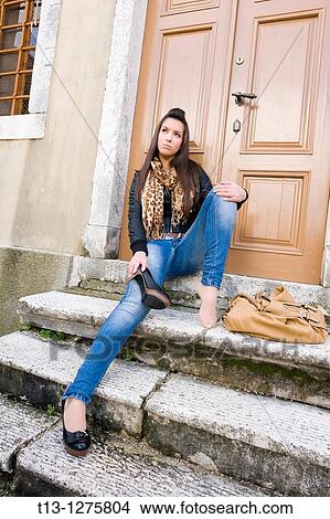 Picture - Tiresome young woman and sore foot. Fotosearch