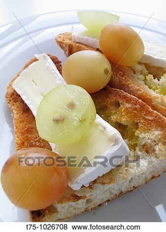 Toasted bread with brie and grapes View Large Photo Image Stock Photo - Toasted bread with brie and grapes. Fotosearch