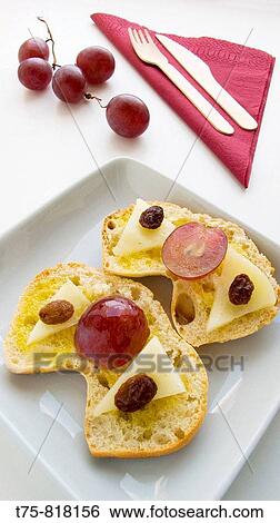 Toasted bread with olive oil, cheese, red grapes and raisins. View Large Photo Image Stock Photograph - Toasted bread with olive oil, cheese, red grapes and raisins.. Fotosearch