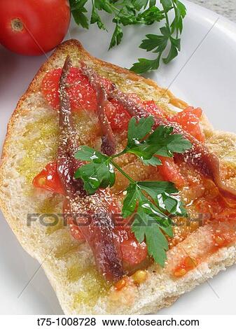 Toasted bread with tomato, olive oil and anchovies View Large Photo Image Stock Photo - Toasted bread with tomato, olive oil and anchovies. Fotosearch