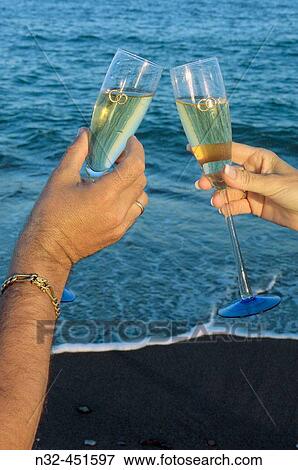 Toasting with champagne on the beach View Large Photo Image Stock Photo - Toasting with champagne on the beach. Fotosearch