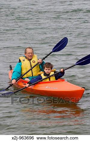 Tobermory, Ontario Canada - August 11, 2004 - John West and his son, Joey, 5, paddle a kayak in Hay Bay on Lake Huron MR View Large Photo Image Stock Photograph - Tobermory, Ontario Canada - August 11, 2004 - John West and his son, Joey, 5, paddle a kayak in Hay Bay on Lake Huron MR. Fotosearch