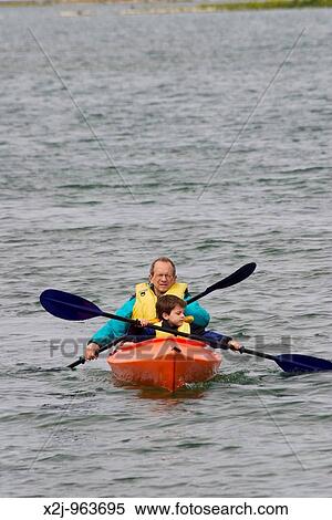 Stock Photography - Tobermory, Ontario Canada - John West and his son, Joey, 5, paddle a kayak in Hay Bay on Lake Huron MR. Fotosearch