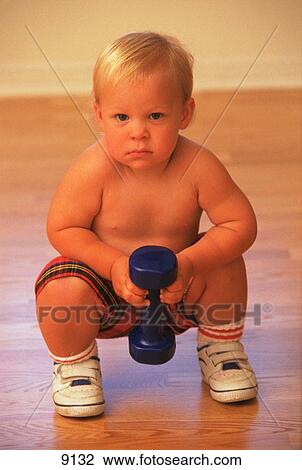 Toddler boy lifts hand weight View Large Photo Image Stock Image - Toddler boy lifts hand weight. Fotosearch