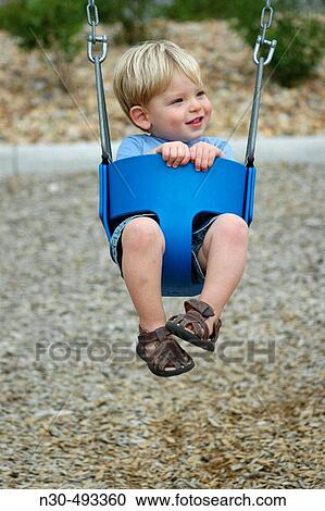 Stock Image - Toddler Boy on Swing. Fotosearch