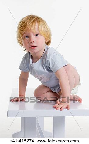 Toddler climbing on a bench View Large Photo Image Picture - Toddler climbing on a bench. Fotosearch
