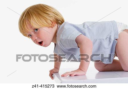 Toddler climbing on a bench View Large Photo Image Stock Image - Toddler climbing on a bench. Fotosearch