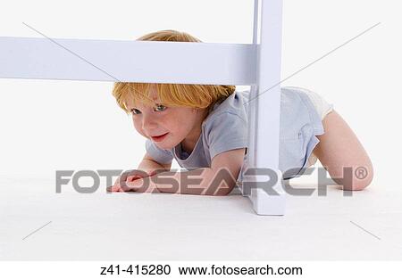 Toddler crawling under a bench View Large Photo Image Stock Image - Toddler crawling under a bench. Fotosearch