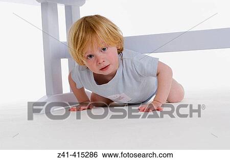 Stock Photograph - Toddler crawling under a bench. Fotosearch