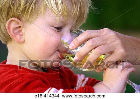 Toddler drinking from wine glass View Large Photo Image Picture - Toddler drinking from wine glass. Fotosearch
