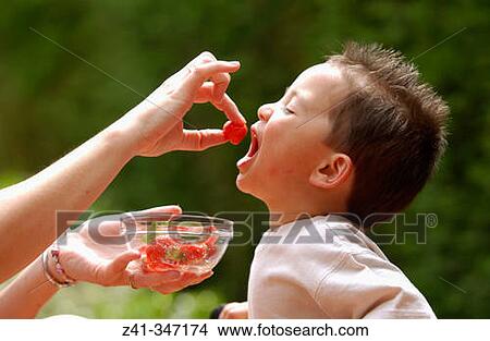 Toddler eating strawberries View Large Photo Image Picture - Toddler eating strawberries. Fotosearch