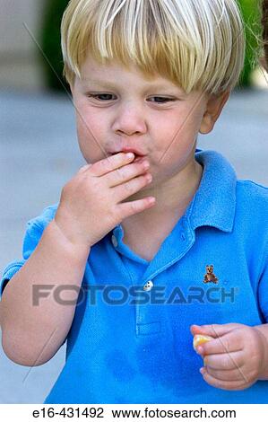 Toddler enjoying orange bite. View Large Photo Image Stock Image - Toddler enjoying orange bite.. Fotosearch