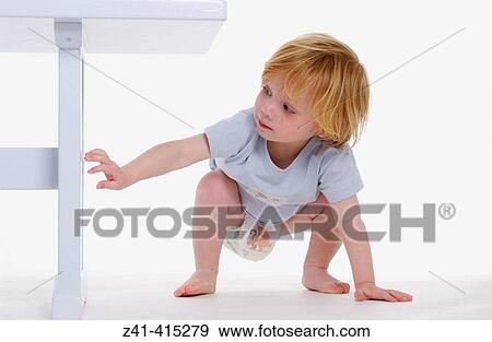 Toddler examining a bench View Large Photo Image Stock Photo - Toddler examining a bench. Fotosearch