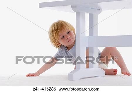 Stock Photography - Toddler examining a bench. Fotosearch