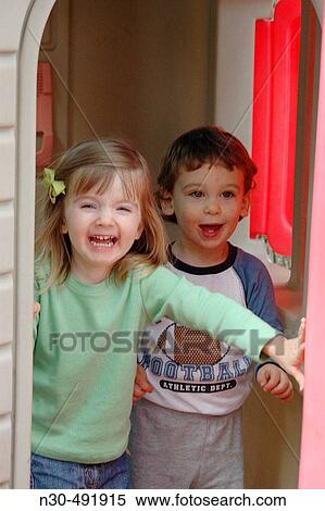 Toddler girl and boy playing in house View Large Photo Image Stock Photography - Toddler girl and boy playing in house. Fotosearch