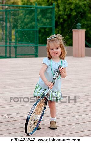 Toddler girl holding tennis racquet View Large Photo Image Stock Image - Toddler girl holding tennis racquet. Fotosearch