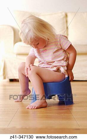 Stock Image - Toddler girl using potty. Fotosearch