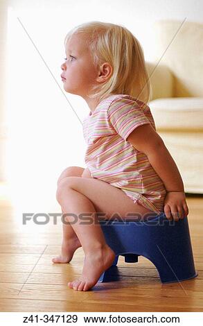 Stock Photo - Toddler girl using potty. Fotosearch