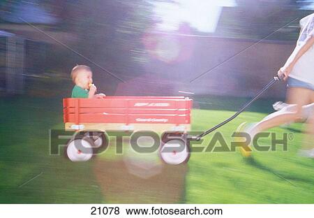 Toddler in wagon View Large Photo Image Stock Photo - Toddler in wagon. Fotosearch