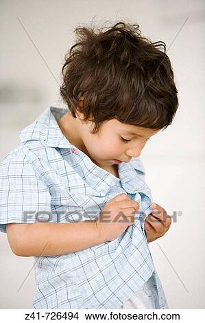 Toddler is trying to dress himself View Large Photo Image Picture - Toddler is trying to dress himself. Fotosearch