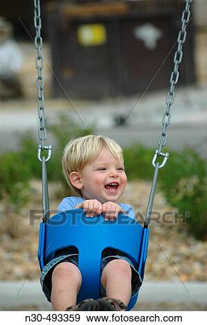 Toddler laughing on swing View Large Photo Image Stock Photo - Toddler laughing on swing. Fotosearch
