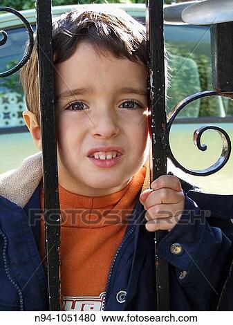 Toddler leaning over the railing looking at the camera. View Large Photo Image Stock Image - Toddler leaning over the railing looking at the camera.. Fotosearch