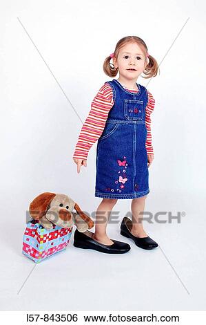 toddler, little girl, wearing dress and grown up dress shoes, standing next to handbag with plush toy doggy, piggy tail hairstyle, white background, studio, Switzerland View Large Photo Image Stock Photograph - toddler, little girl, wearing dress and grown up dress shoes, standing next to handbag with plush toy doggy, piggy tail hairstyle, white background, studio, Switzerland. Fotosearch