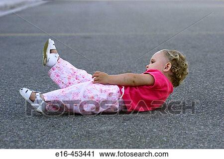 toddler lying on street View Large Photo Image Stock Image - toddler lying on street. Fotosearch