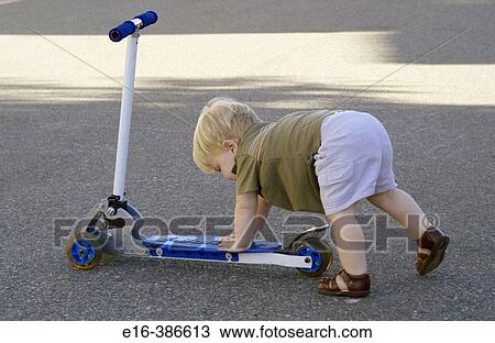 toddler pushing scooter View Large Photo Image Stock Image - toddler pushing scooter. Fotosearch