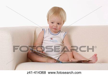 Toddler reads a book View Large Photo Image Stock Photo - Toddler reads a book. Fotosearch
