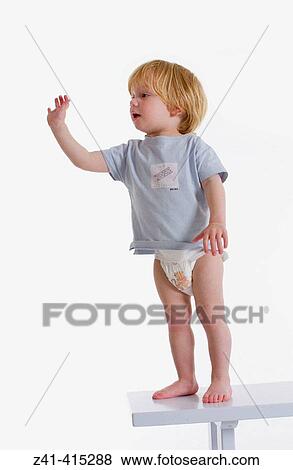 Stock Photo - Toddler standing on a bench. Fotosearch