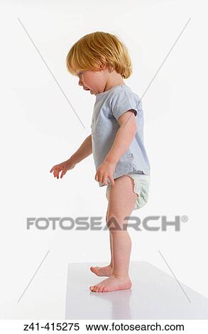 Toddler standing on a bench View Large Photo Image Stock Photography - Toddler standing on a bench. Fotosearch