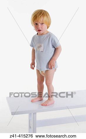 Toddler standing on bench View Large Photo Image Stock Photograph - Toddler standing on bench. Fotosearch