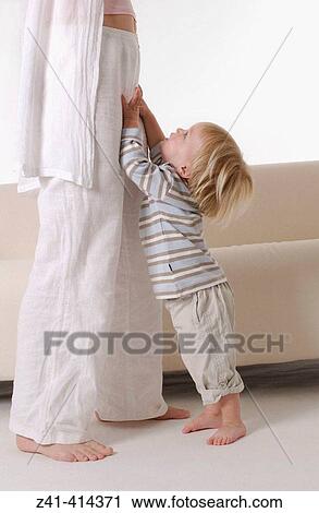 Toddler standing with mothers legs View Large Photo Image Stock Image - Toddler standing with mothers legs. Fotosearch