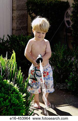 toddler watering with garden hose View Large Photo Image Picture - toddler watering with garden hose. Fotosearch