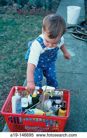 Stock Photography - Toddler with cleaning products. Fotosearch