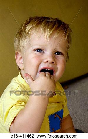 Toddler with hands in mouth View Large Photo Image Stock Image - Toddler with hands in mouth. Fotosearch