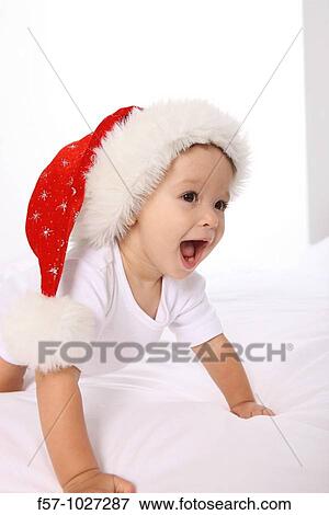 Stock Photo - Toddler with Santa cap. Fotosearch