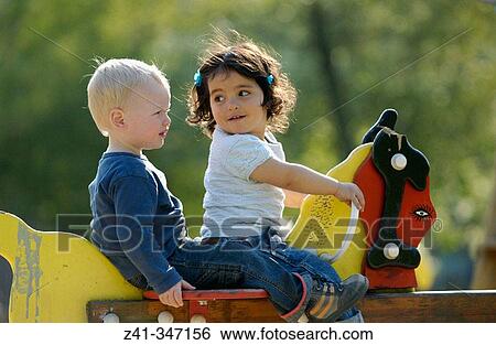 Toddlers in playground View Large Photo Image Stock Photograph - Toddlers in playground. Fotosearch