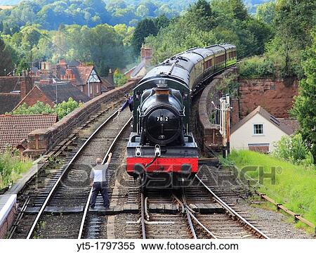 Tokens exchanged as No 7812 Erlestock Manor pullas a passenger train into Bewdley station, Worcestershire, England, Europe View Large Photo Image Stock Photography - Tokens exchanged as No 7812 Erlestock Manor pullas a passenger train into Bewdley station, Worcestershire, England, Europe. Fotosearch